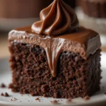 Chocolate Fudge Cake 3 Close-up of a moist, fudgy chocolate cake bite with glossy chocolate frosting
