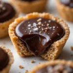 Chocolate Ganache Tartlets 3 Close-up of a chocolate ganache tartlet with glossy filling and crispy crust