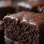 Flourless Chocolate Cake 3 Close-up of a gooey, glossy bite of flourless chocolate cake with a dense and fudgy texture