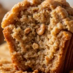Maple Walnut Muffins 3 Close-up of a golden-brown maple walnut muffin with walnut pieces