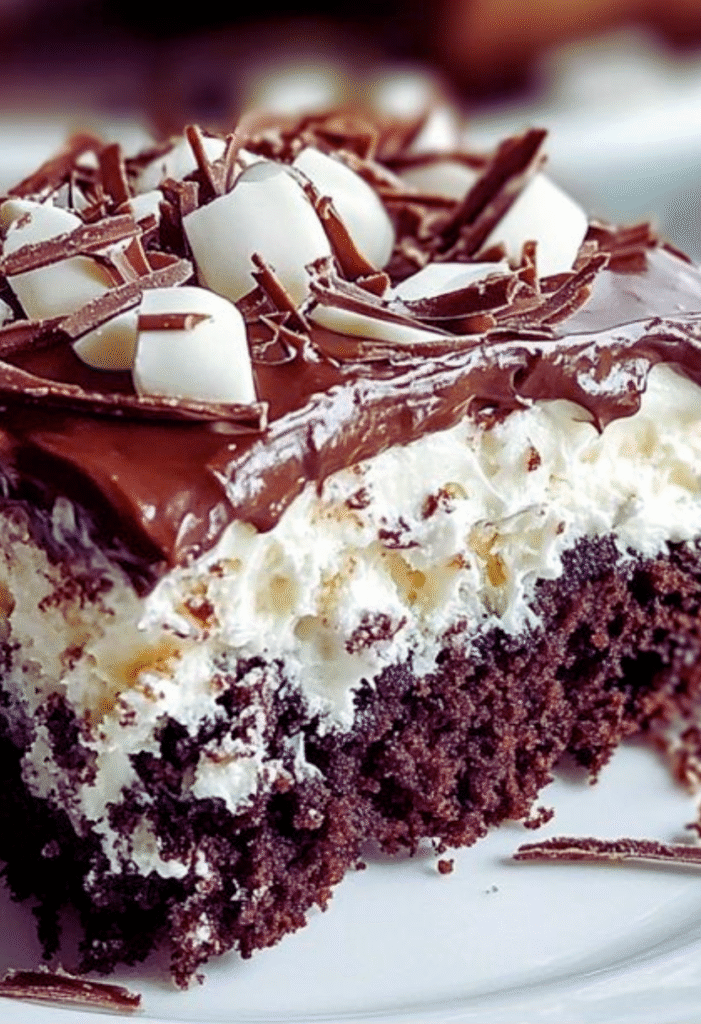 Slice of Mounds poke cake with chocolate ganache and shredded coconut